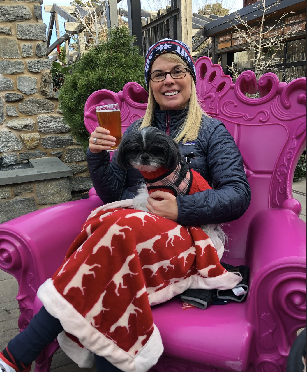 Chris sitting outdoors with her dog